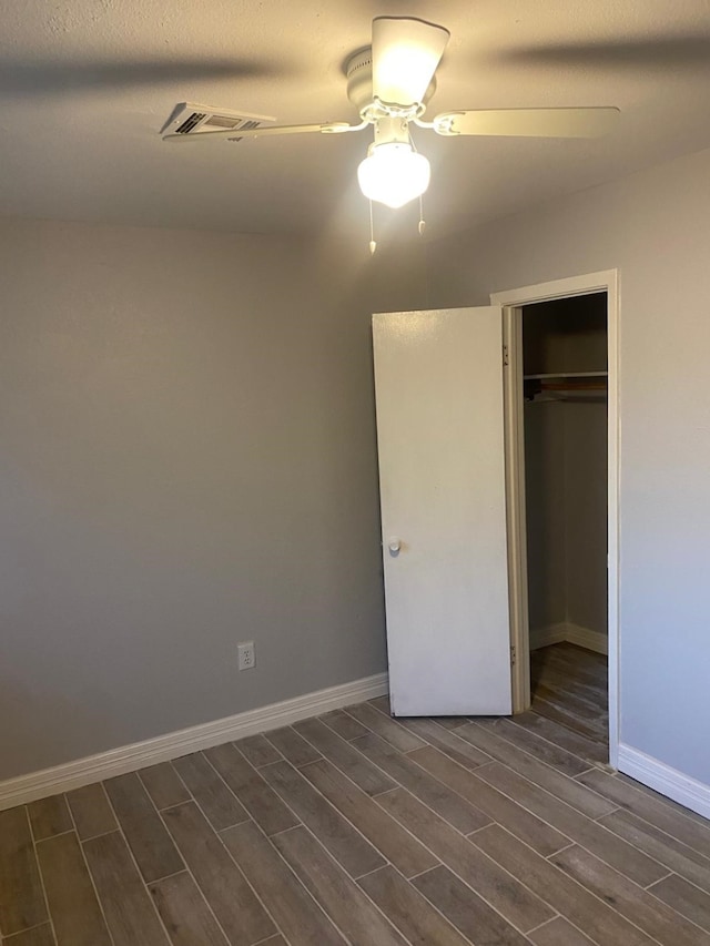 14418 Alkay St, Houston, TX 77045 - unfurnished bedroom featuring a closet, ceiling fan, visible vents, baseboards, and wood finish floors
