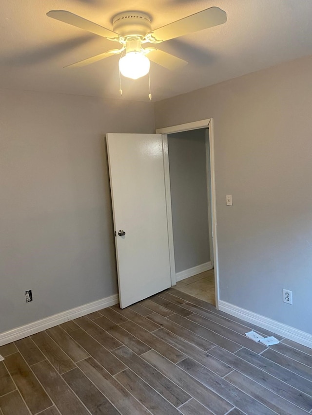 14418 Alkay St, Houston, TX 77045 - unfurnished bedroom with baseboards, wood finish floors, and ceiling fan