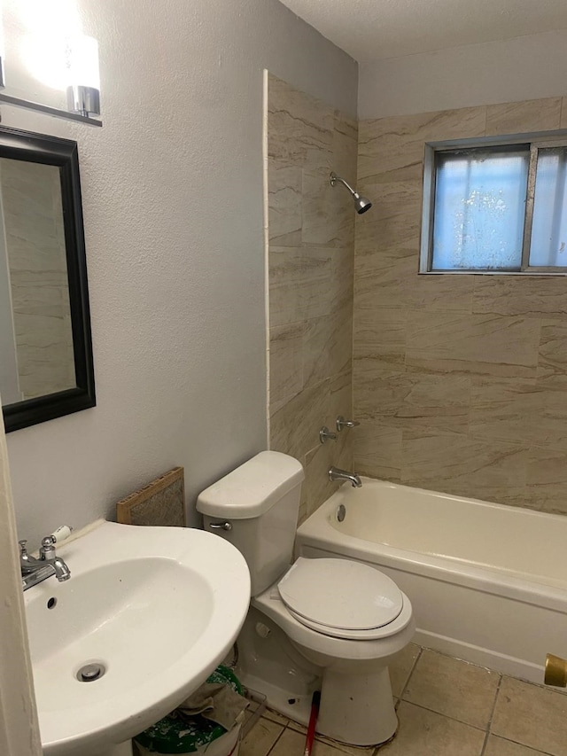 14418 Alkay St, Houston, TX 77045 - bathroom featuring toilet, tile patterned flooring, a sink, and washtub / shower combination