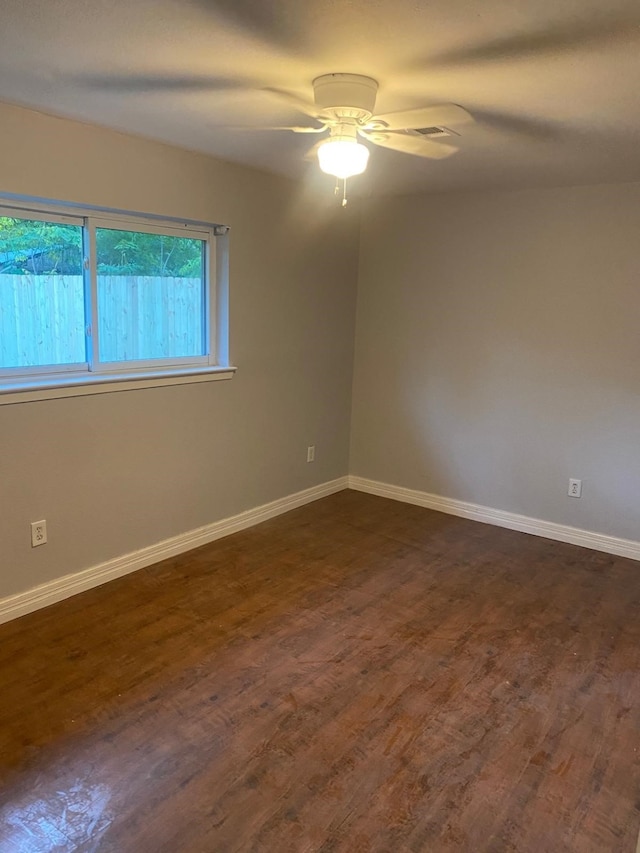 14418 Alkay St, Houston, TX 77045 - unfurnished room with a ceiling fan, dark wood-style flooring, and baseboards