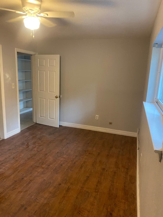 14418 Alkay St, Houston, TX 77045 - unfurnished bedroom featuring dark wood-type flooring, ceiling fan, and baseboards