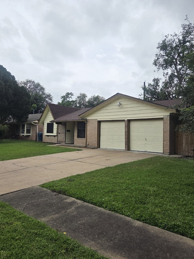14418 Alkay St, Houston, TX 77045 - ranch-style house featuring a front lawn, driveway, a garage, and brick siding
