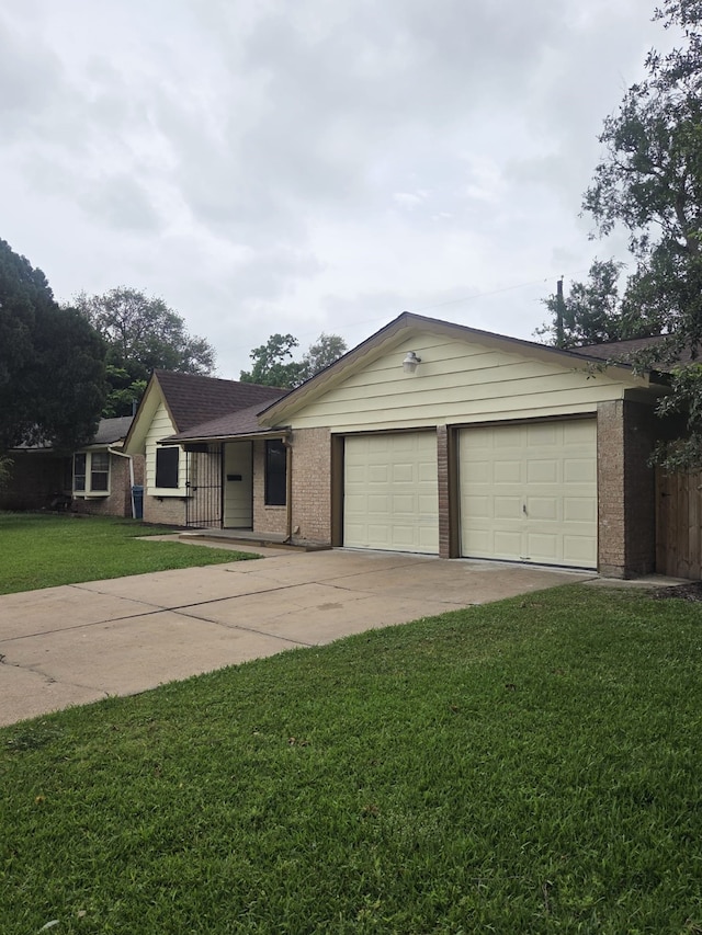 14418 Alkay St, Houston, TX 77045 - single story home featuring concrete driveway, a front yard, a garage, and brick siding