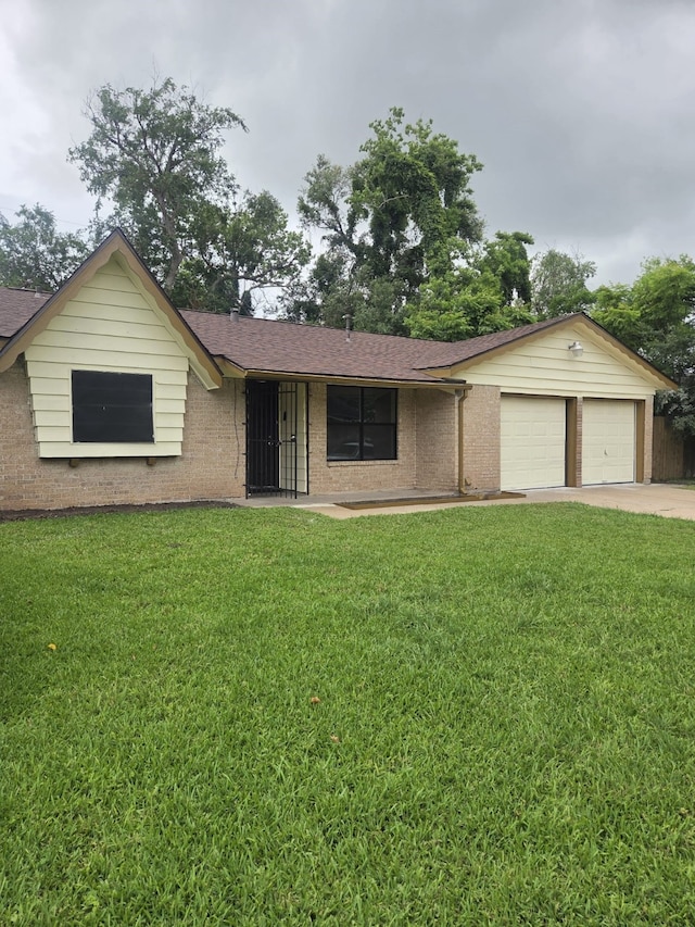 14418 Alkay St, Houston, TX 77045 - ranch-style home with concrete driveway, brick siding, a front lawn, and a garage