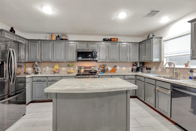 kitchen with visible vents, gray cabinetry, a sink, and appliances with stainless steel finishes