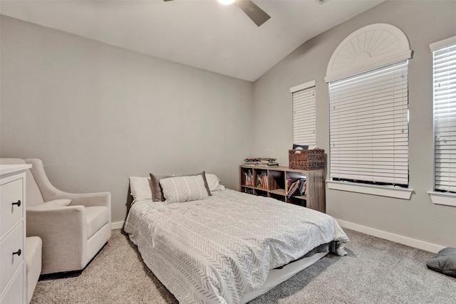 bedroom with light colored carpet, ceiling fan, lofted ceiling, and baseboards