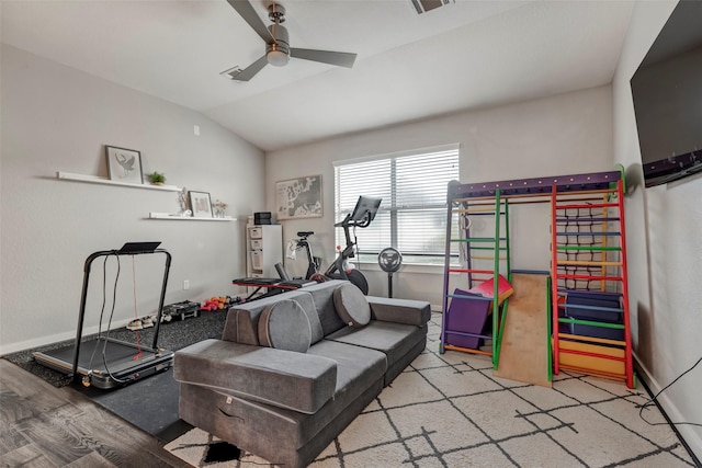 interior space with baseboards, visible vents, lofted ceiling, wood finished floors, and ceiling fan