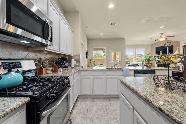 3639 Daintree Park Dr, Katy, TX 77494 - kitchen featuring stainless steel appliances, backsplash, a ceiling fan, white cabinets, and recessed lighting