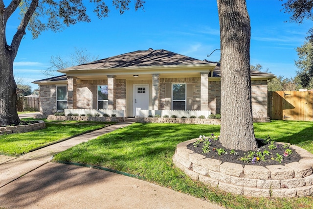7810 Blackjack Ct, Houston, TX 77088 - view of front facade with brick siding, a front lawn, and fence