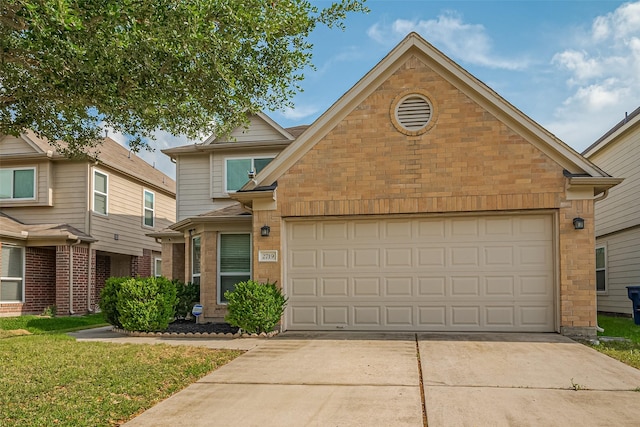 traditional-style house with an attached garage, brick siding, and concrete driveway