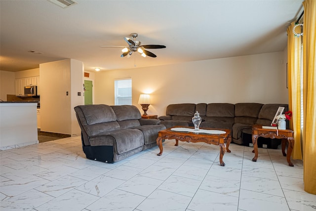 living area with visible vents, marble finish floor, and ceiling fan