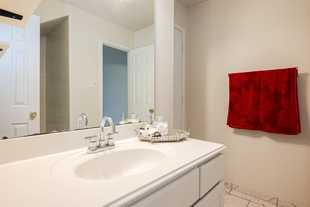 bathroom with marble finish floor and vanity