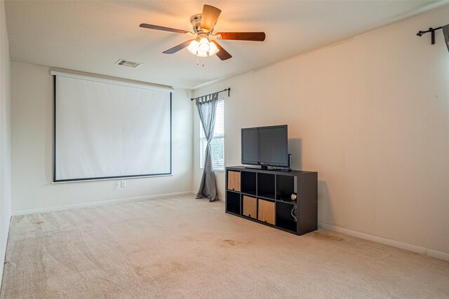 interior space featuring baseboards, a ceiling fan, and visible vents
