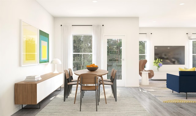 dining room with recessed lighting and wood finished floors