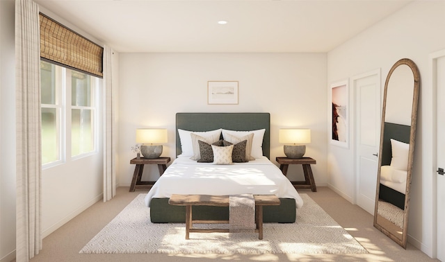 bedroom with light carpet and baseboards