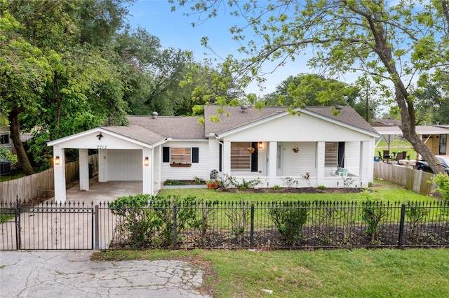 view of front of property with concrete driveway, a carport, a shingled roof, and a garage
