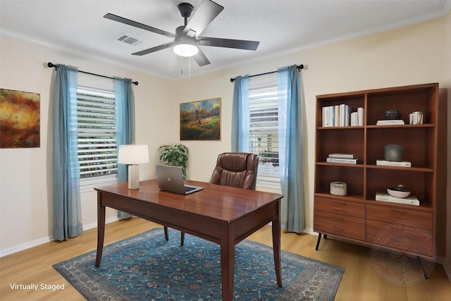 home office with light wood-style floors, ceiling fan, healthy amount of natural light, and crown molding