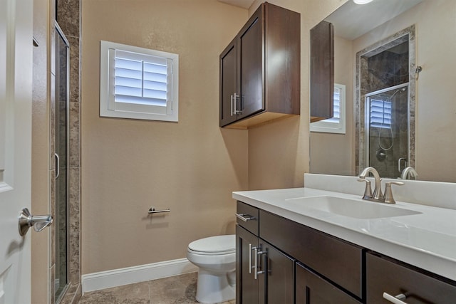 bathroom with vanity, baseboards, a shower stall, and toilet