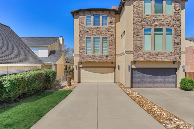 townhome / multi-family property with stone siding, an attached garage, driveway, and stucco siding