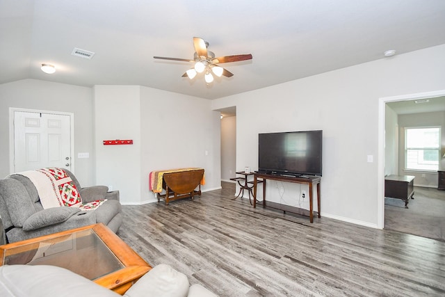 living area with visible vents, baseboards, a ceiling fan, and wood finished floors