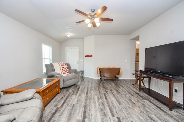 living area featuring vaulted ceiling, a ceiling fan, light wood-style flooring, baseboards, and visible vents