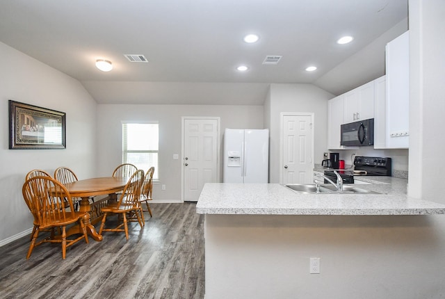 kitchen with lofted ceiling, visible vents, and black appliances