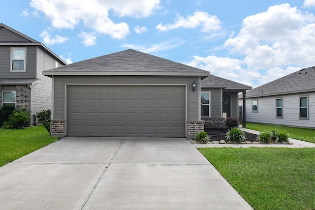 view of front of home featuring brick siding, a front lawn, driveway, and an attached garage