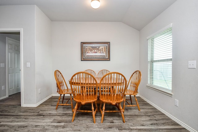 dining room with lofted ceiling, baseboards, wood finished floors, and a healthy amount of sunlight