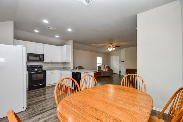 dining space featuring dark wood-style floors, visible vents, recessed lighting, lofted ceiling, and a ceiling fan