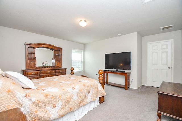 bedroom featuring baseboards, visible vents, and light colored carpet