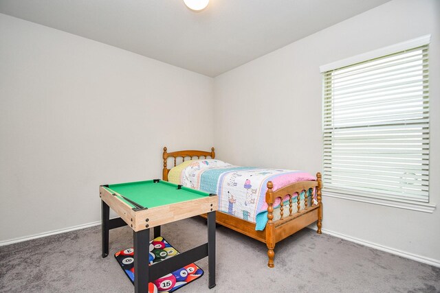 carpeted bedroom featuring baseboards