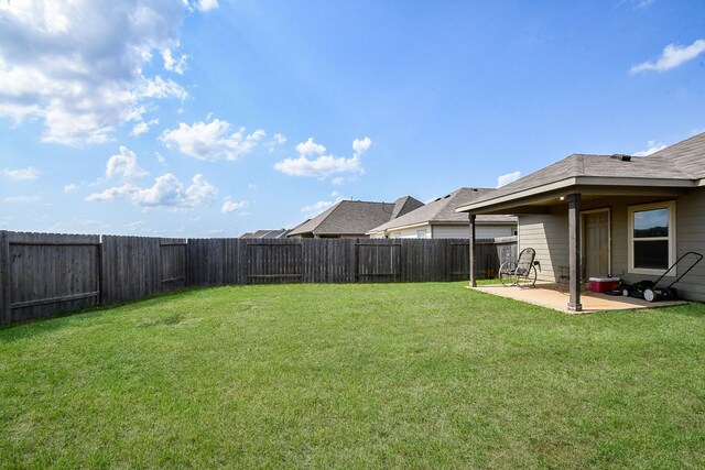 view of yard with a fenced backyard and a patio
