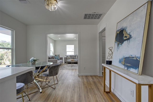 4716 Siegel St, Houston, TX 77009 - dining room featuring visible vents, wood finished floors, and baseboards