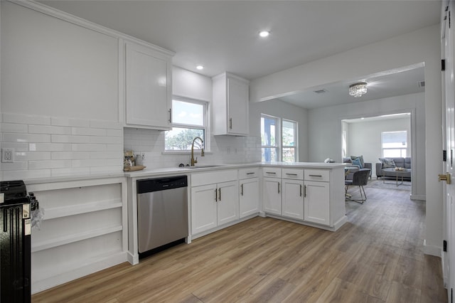 4716 Siegel St, Houston, TX 77009 - kitchen with stainless steel dishwasher, a sink, decorative backsplash, light wood-style floors, and light countertops