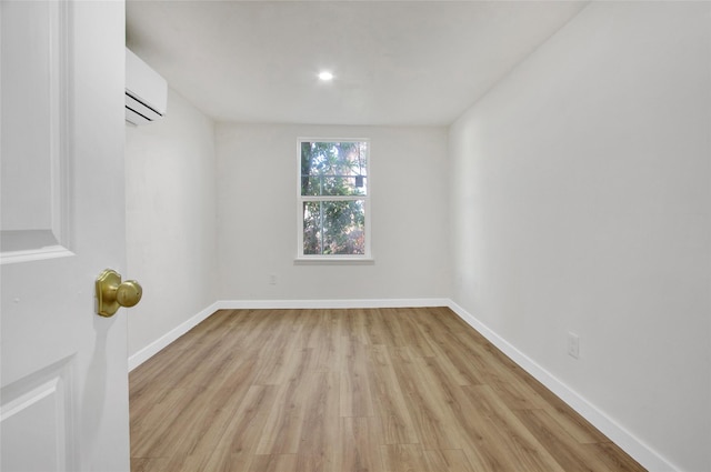 4716 Siegel St, Houston, TX 77009 - unfurnished room featuring a wall mounted AC, baseboards, and light wood-type flooring