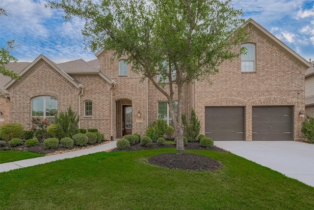 view of front of home featuring concrete driveway, a front lawn, brick siding, and a garage