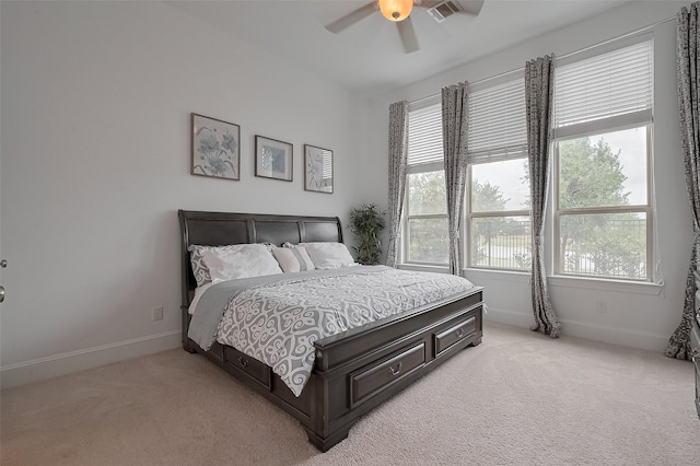 bedroom featuring light colored carpet, baseboards, a ceiling fan, and visible vents