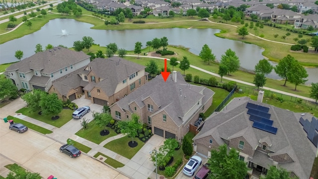 drone / aerial view with a residential view and a water view