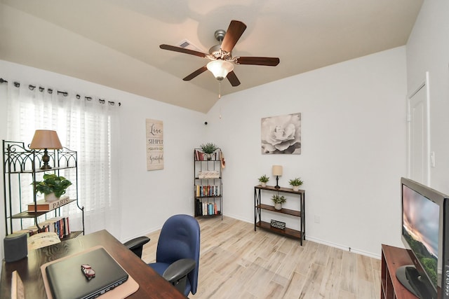 office space featuring lofted ceiling, a ceiling fan, light wood finished floors, and baseboards