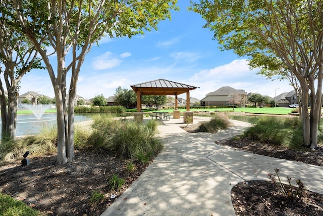 view of community with a gazebo, a water view, and a residential view