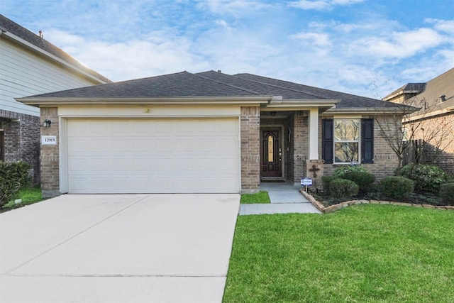view of front facade featuring a front lawn, a garage, a shingled roof, driveway, and brick siding