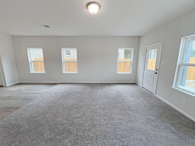 interior space with baseboards and visible vents