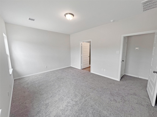 unfurnished bedroom featuring baseboards, visible vents, and carpet flooring