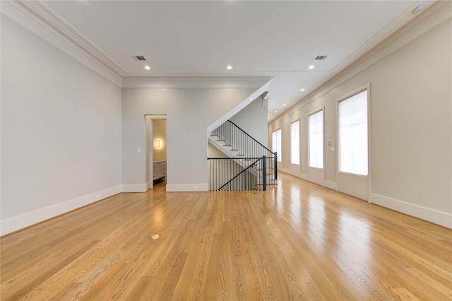 1509 Caywood Ln Unit C, Houston, TX 77055 - unfurnished living room featuring crown molding, baseboards, stairs, light wood-type flooring, and recessed lighting