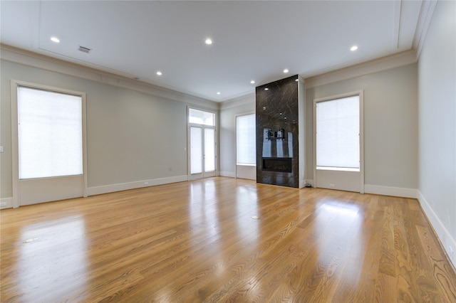 1509 Caywood Ln Unit C, Houston, TX 77055 - unfurnished living room with crown molding, a fireplace, baseboards, light wood finished floors, and recessed lighting