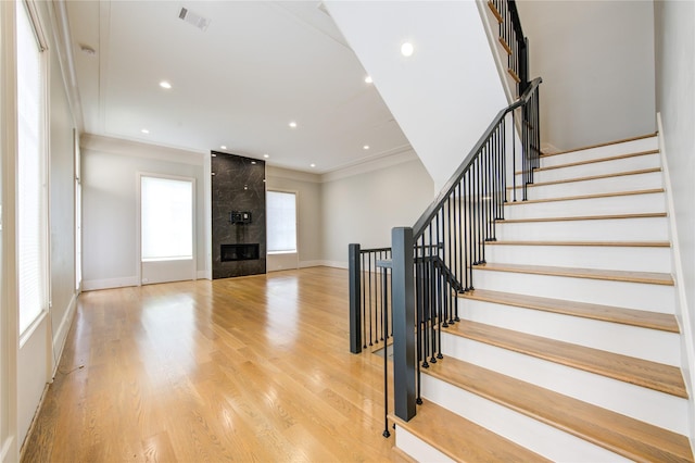 1509 Caywood Ln Unit C, Houston, TX 77055 - stairway featuring ornamental molding, wood finished floors, recessed lighting, baseboards, and a high end fireplace
