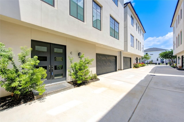 1509 Caywood Ln Unit C, Houston, TX 77055 - doorway to property with an attached garage, stucco siding, driveway, and french doors