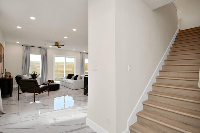 stairs featuring marble finish floor, baseboards, ceiling fan, and recessed lighting