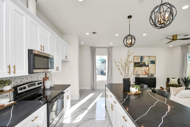 kitchen with tasteful backsplash, dark countertops, visible vents, marble finish floor, and appliances with stainless steel finishes