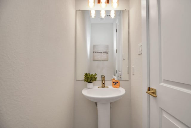 bathroom with a notable chandelier